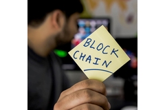 Image A man holding a block chain note paper